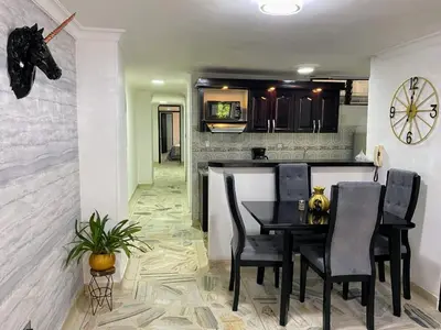 a kitchen and dining room with a table and chairs at apartamento 3 habitaciones cerca al parque del poblado in Medellín