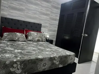a bedroom with a bed and a black door at apartamento 3 habitaciones cerca al parque del poblado in Medellín