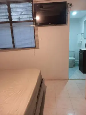 a bedroom with a bed and a flat screen tv at apartamento 3 habitaciones cerca al parque del poblado in Medellín