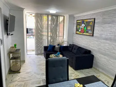 a living room with a couch and a tv at apartamento 3 habitaciones cerca al parque del poblado in Medellín