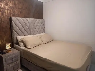 a small bedroom with a bed and a nightstand at apartamento 3 habitaciones cerca al parque del poblado in Medellín