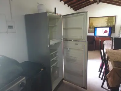 a refrigerator with its door open in a room at Casa de campo barbosa Antioquia in Barbosa