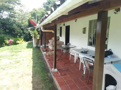 a patio of a house with a table and chairs at Casa de campo barbosa Antioquia in Barbosa