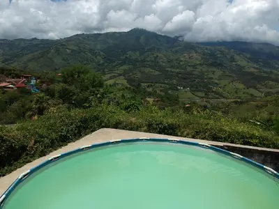 a swimming pool with a view of a mountain at Casa de campo barbosa Antioquia in Barbosa