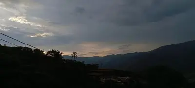 a view of a mountain with the sun setting at Casa de campo barbosa Antioquia in Barbosa