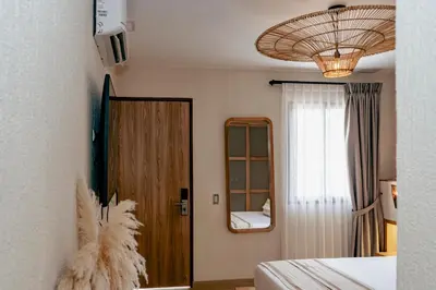 a room with a door and a mirror and a window at La Gracia Hotel & Spa in San Jerónimo
