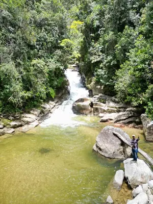 a person standing on a rock in a river at Reserva Natural Maimará in Alejandría