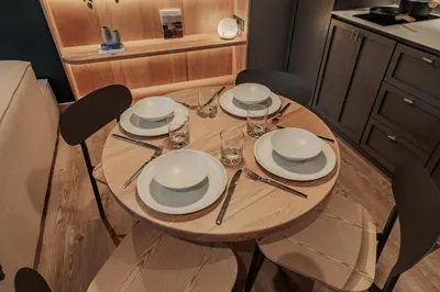 a wooden table with plates and glasses on it at H10 - Provenza in Medellín
