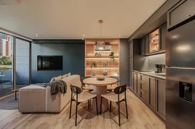 a kitchen and living room with a table and a couch at H10 - Provenza in Medellín