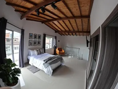 a bedroom with a bed and a wooden ceiling at Hermoso Loft cerca al poblado y al metro in Medellín