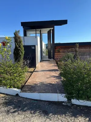 a house with a walkway leading to the front door at Mountain Home Close to Guatape Pueblo With Jacuzzi in Guatapé