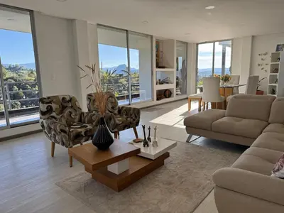 a living room with two couches and a table at Mountain Home Close to Guatape Pueblo With Jacuzzi in Guatapé