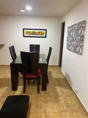 a dining room with a black table and chairs at Acogedor loft, para 4 huéspedes Medellín Antioquia in Medellín