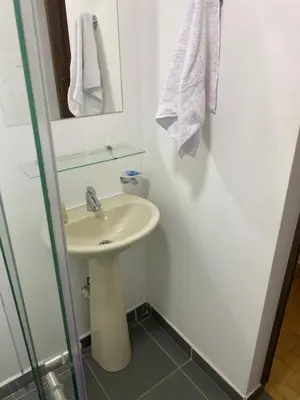 a bathroom with a sink and a mirror at Acogedor loft, para 4 huéspedes Medellín Antioquia in Medellín