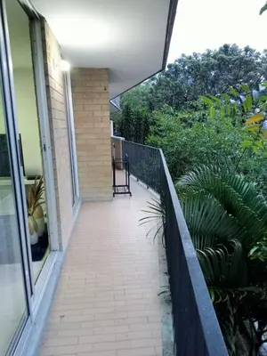 a balcony of a house with a chair on it at Apartment in Palmas - Poblado in Medellín