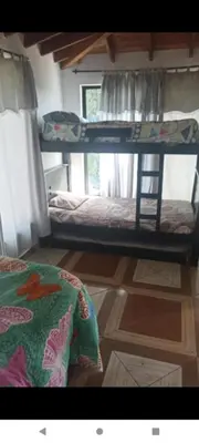 a room with two bunk beds and a wooden floor at Finca Barbosa Antioquia in Fredonia