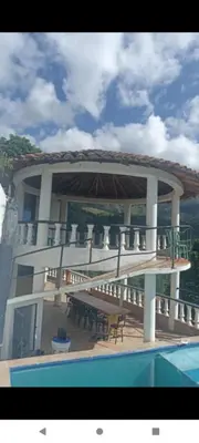 a large building with a table and a swimming pool at Finca Barbosa Antioquia in Fredonia