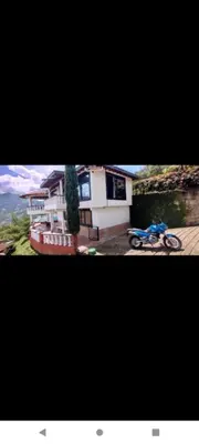 a motorcycle parked in front of a house at Finca Barbosa Antioquia in Fredonia