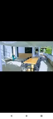 a group of tables and chairs in a building at Finca Barbosa Antioquia in Fredonia