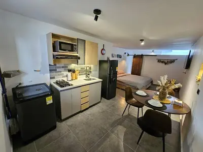 a small kitchen with a small table in a room at Estupendo Loft en El Poblado in Medellín