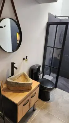 a bathroom with a sink and a toilet and a mirror at Estupendo Loft en El Poblado in Medellín