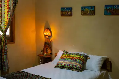 a bedroom with a bed with a clock on the wall at Luna Verde Eco Hábitat in Rionegro