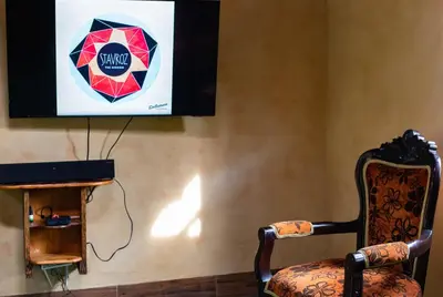 a chair sitting in front of a screen with a television at Luna Verde Eco Hábitat in Rionegro