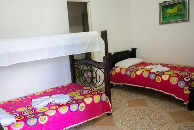 a bedroom with two bunk beds with pink sheets at Hotel Quinchia in Quinchía