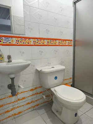 a bathroom with a toilet and a sink at Hotel Quinchia in Quinchía