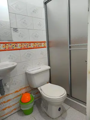 a bathroom with a toilet and a sink and a shower at Hotel Quinchia in Quinchía