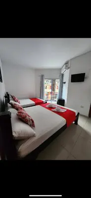 a bedroom with two beds and a window at Hotel Los Balcones in Doradal