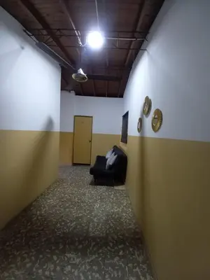a room with a couch in the middle of a hallway at Hospedaje Ricaribe in Medellín