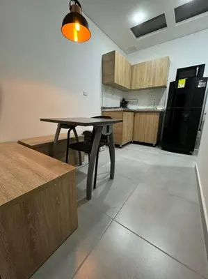 a kitchen with a table and a black refrigerator at Loft Zen en Envigado in Envigado