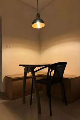 a table and a chair in a room with a light at Loft Zen en Envigado in Envigado