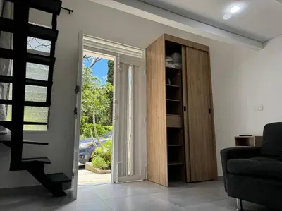 a living room with a sliding glass door and a couch at Loft Zen en Envigado in Envigado