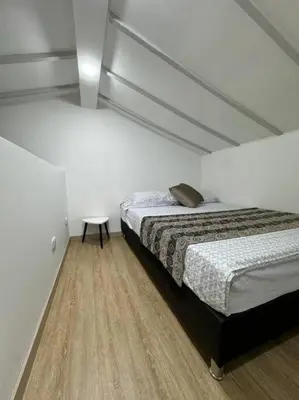 a bedroom with two beds and a table in it at Loft Zen en Envigado in Envigado