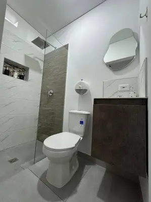 a white bathroom with a toilet and a shower at Loft Zen en Envigado in Envigado