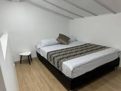 a bedroom with a bed and a small table at Loft Zen en Envigado in Envigado