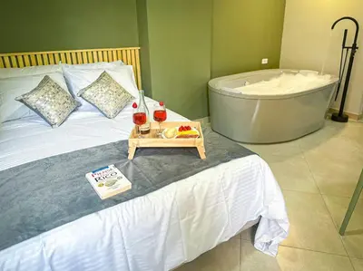 a bed with a tub and a tray of fruit on it at Loft moderno con bañera Medellín 1-03 in Medellín