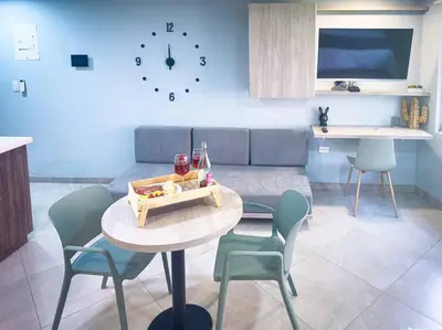 a living room with a table with chairs and a couch at Loft moderno con bañera Medellín 1-03 in Medellín