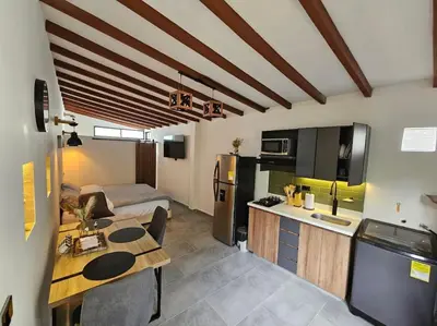 a room with a kitchen and a living room at Nuevo Loft en el Poblado in Medellín