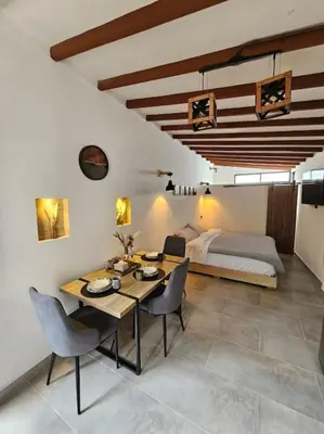 a room with a table and chairs and a bed at Nuevo Loft en el Poblado in Medellín