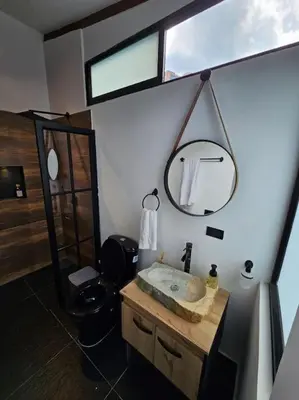 a bathroom with a sink and a mirror and a toilet at Nuevo Loft en el Poblado in Medellín