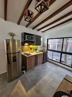 a kitchen with a stainless steel refrigerator in a room at Nuevo Loft en el Poblado in Medellín