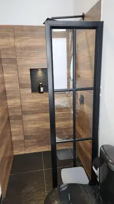 a bathroom with a toilet and a wooden wall at Nuevo Loft en el Poblado in Medellín
