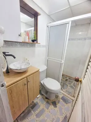 a bathroom with a toilet and a sink and a shower at Exclusivo apartamento en Estadio in Medellín