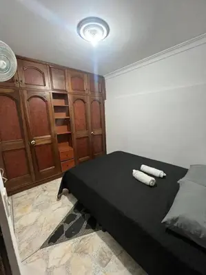 a bedroom with a bed with two white towels on it at exclusivo apartamento laureles in Medellín