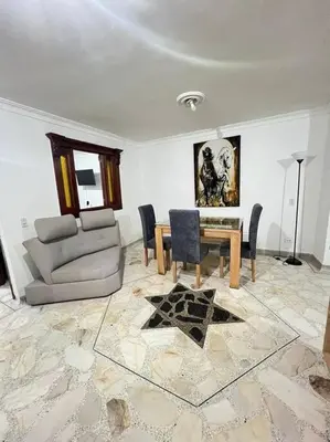 a living room with a couch and a table at exclusivo apartamento laureles in Medellín
