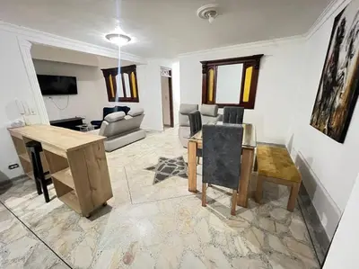 a living room with a table and a couch at exclusivo apartamento laureles in Medellín