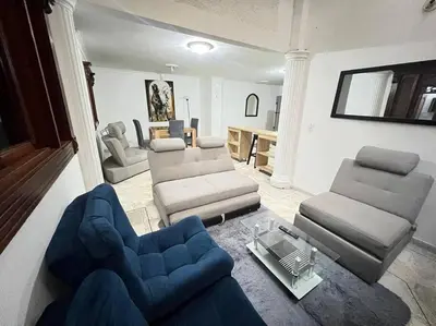 a living room with a couch and chairs and a table at exclusivo apartamento laureles in Medellín